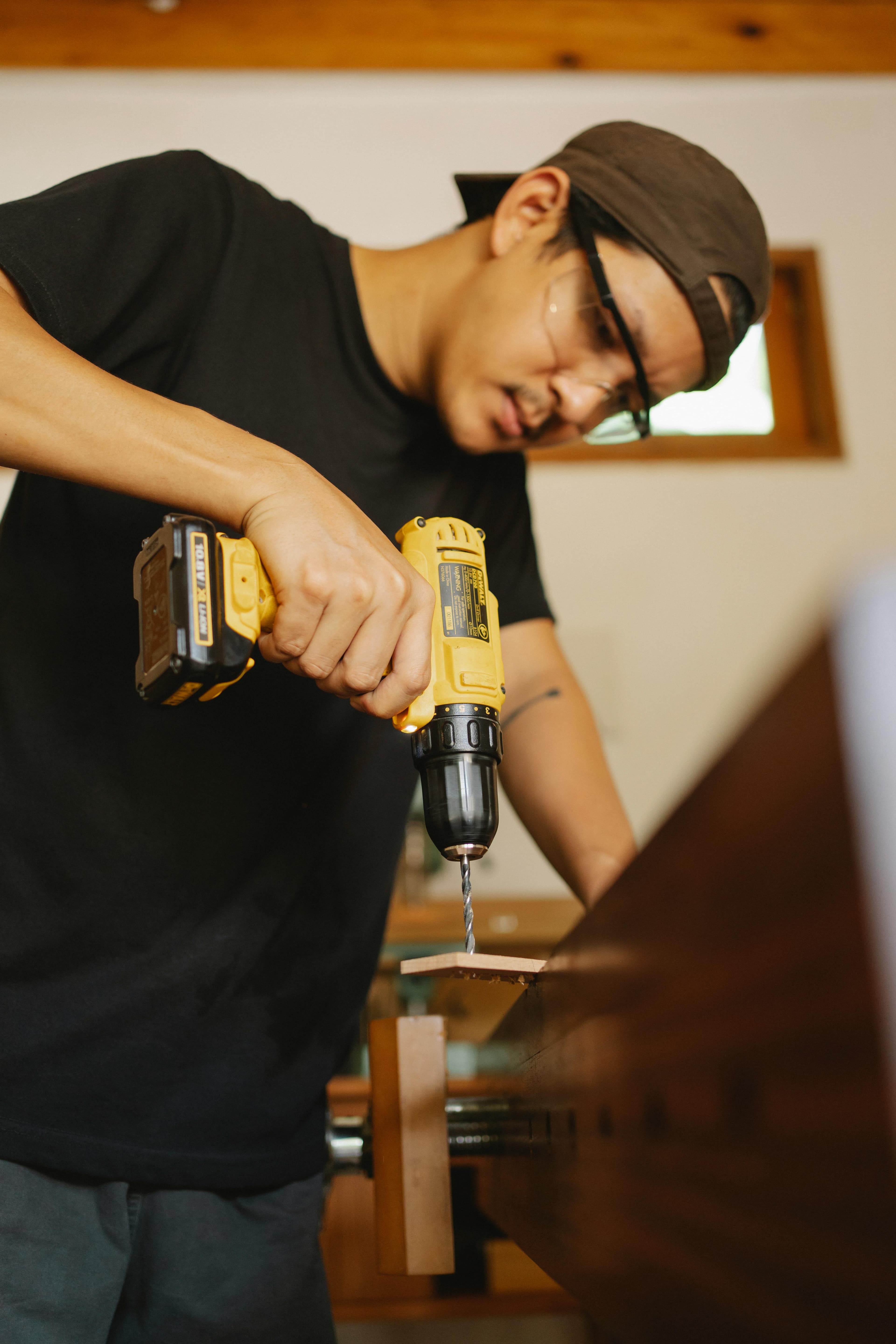 Carpintero utilizando un taladro Dewalt para ensamblar una estructura.