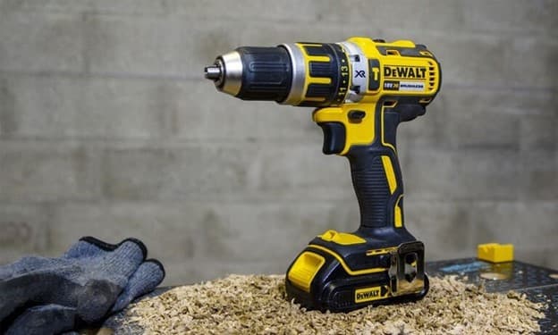Taladro Dewalt inalámbrico sobre suelo de construcción, parte de las herramientas de Ferretería Guevara.